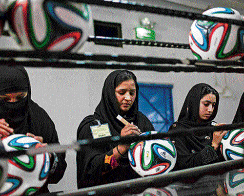 Footballs get finishing touches in a Sialkot factory. Reuters