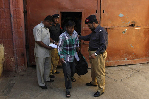 A fisherman from India (C) leaves after his release from Karachi's District Jail Malir, May 25, 2014. Pakistani authorities on Sunday released 58 detained Indian fishermen, who were imprisoned for illegally venturing into the country's territorial waters, and a civilian from District Jail Malir as a goodwill gesture between the two countries ahead of the swearing-in ceremony of the new Indian government led by Narendra Modi on Monday, local media reported. REUTERS