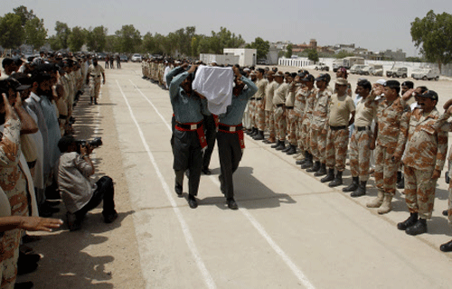 Troops of Pakistani paramilitary forces carry a coffin of their colleague who died during an operation against late Sunday's attack by gunmen who stormed the Jinnah International Airport, during his funeral in Karachi, Pakistan. AP photo