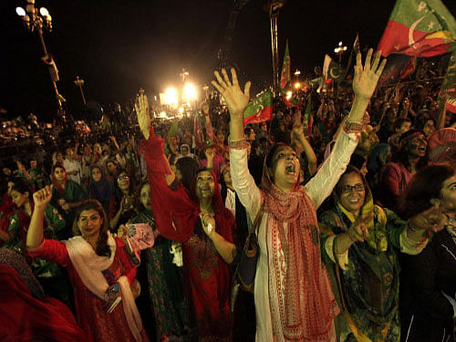 Supporters of chairman of the Pakistan Tehreek-e-Insaf (PTI) political party Imran Khan, a former international cricketer, cheer while listening to him speak during what has been dubbed a 'freedom march' in Islamabad. Opposition leader Khan opened negotiations Wednesday with the Pakistani government, a lawmaker from his party said, in an effort to end protests against the prime minister and overcome a political impasse. Reuters photo