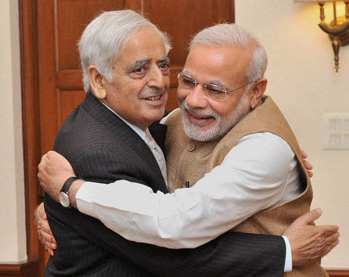 Prime Minister Narendra Modi embraces PDP patron Mufti Mohammad Sayeed during a meeting in New Delhi on Friday. PTI Photo