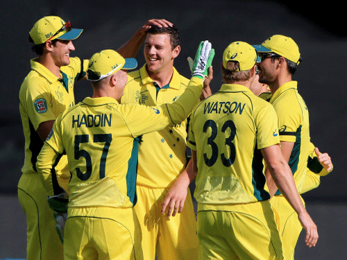 Josh Hazlewood, centre, is congratulated by teammates after taking the wicket of Pakistan's Sohaib Maqsood during their Cricket World Cup quarterfinal match in Adelaide. AP photo