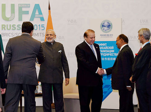 Prime Minister Narendra Modi and his Pakistani Counterpart Nawaz Sharif greet delegation members during a meeting at UFA in Russia on Friday.PTI Photo