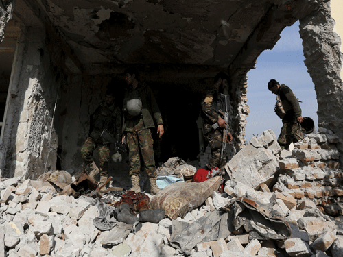 Afghan National Army (ANA) soldiers inspect a damaged building after a blast near the Pakistani consulate in Jalalabad. Reuters Photo.