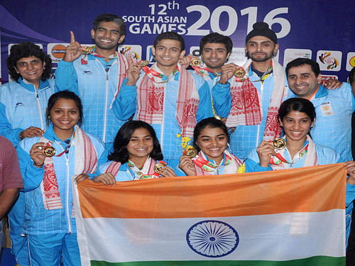 Indian men and women team members pose with their medals after winning gold medal for Squash team event at the 12th South Asian Games at RG Borooah Sports Complex in Guwahati on Wednesday. PTI Photo