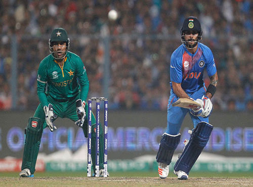 India v Pakistan- World Twenty20 cricket tournament - Kolkata, India, 19/03/2016. India's Virat Kohli (R) plays a shot watched by Pakistan's wicketkeeper Sarfraz Ahmed. REUTERS
