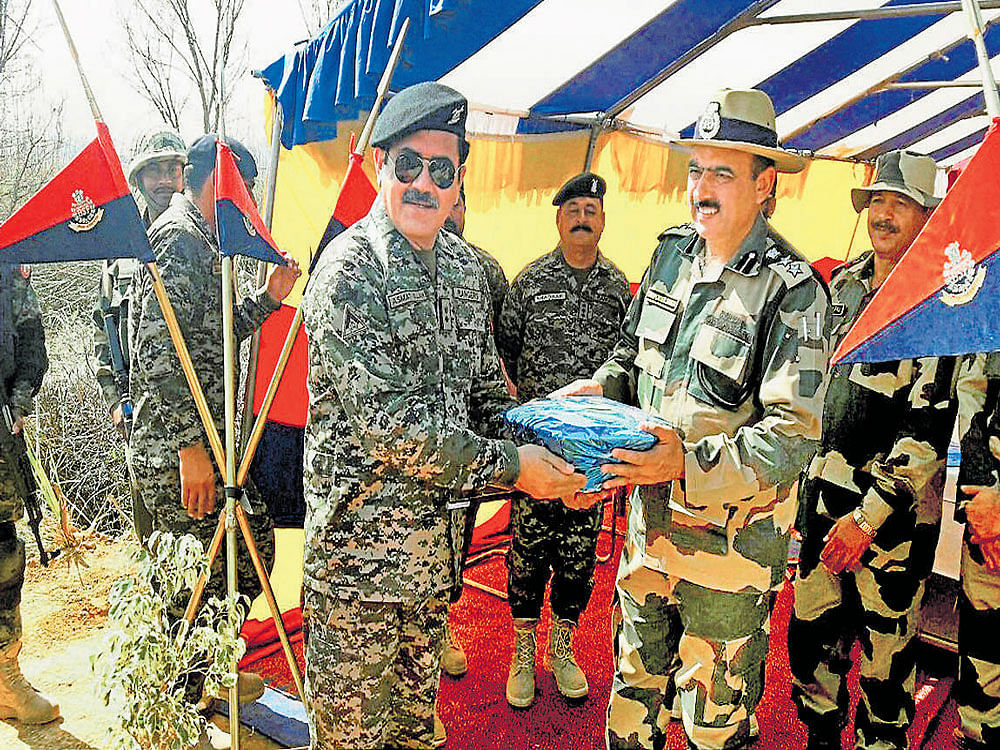 BSF officers with Pak Rangers during a Wing Commander-Commandant level  meeting at Kathua sector on the International Border in Jammu on Friday. PTI