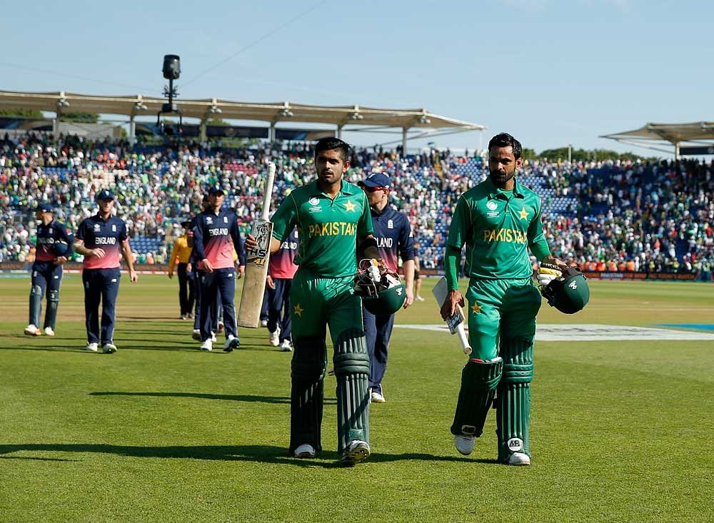 Pakistan's Mohammad Hafeez and Babar Azam acknowledge the crowd as they walk off after winning the match. Reuters Photo
