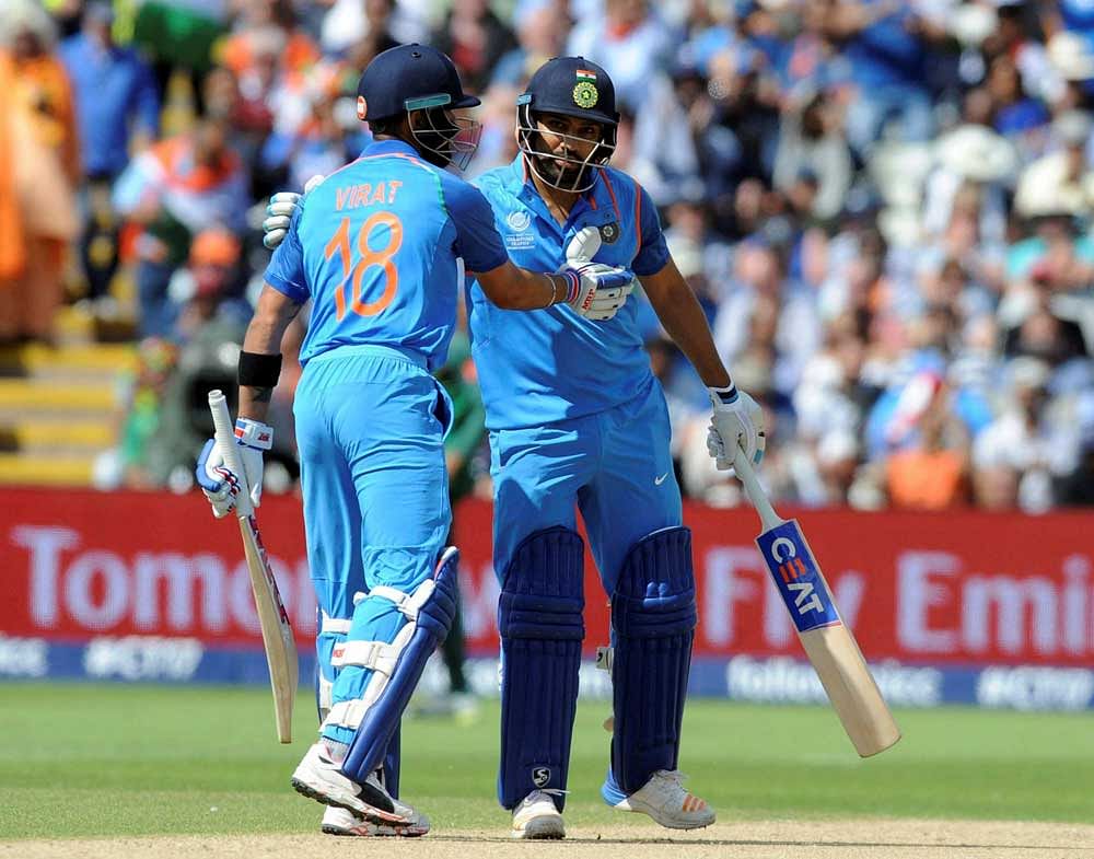 India captain Virat Kohli, left, congratulates India's Rohit Sharma after he reached a century during the ICC Champions Trophy semifinal match between Bangladesh and India at Edgbaston in Birmingham, England, Thursday, June 15, 2017. AP/PTI