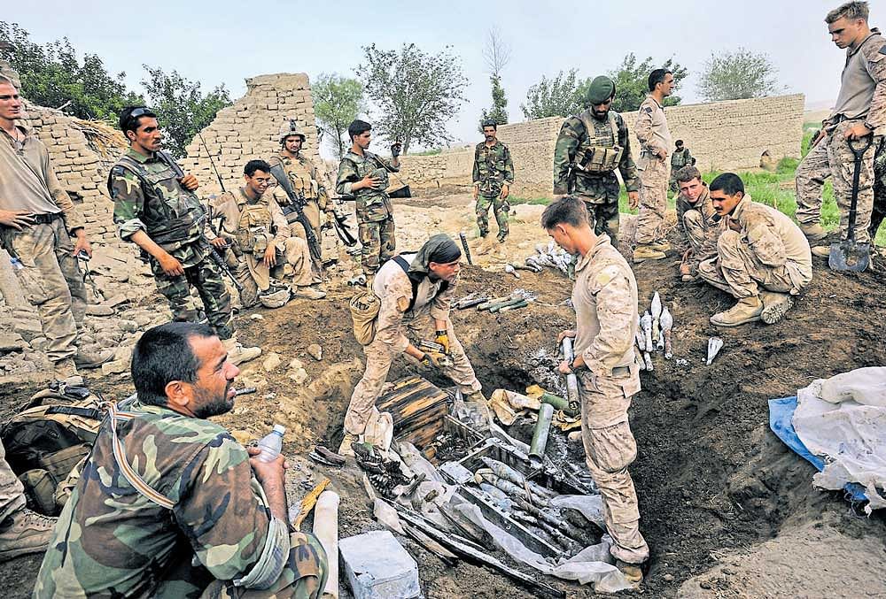 US Marines search for weapons in Helmand, Afghanistan. NYT  file photo
