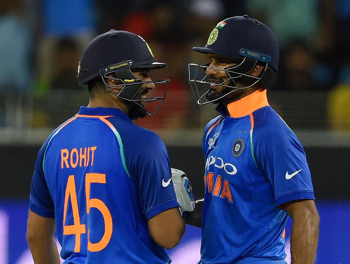 Indian cricket team captain Rohit Sharma (L) and teammate Shikhar Dhawan greet each other during the one day international (ODI) Asia Cup cricket match between Pakistan and India at the Dubai International Cricket Stadium in Dubai on September 19, 2018. (AFP Photo)