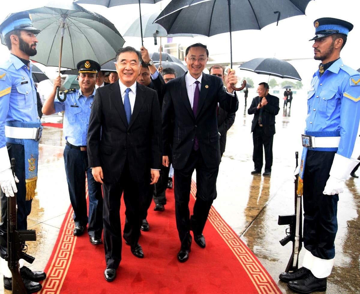 Chinese Vice Premier Wang Yang (C-L) is flanked by Chinese Ambassador to Pakistan Sun Weidong (C-R) as he arrives at the Pakistan's military Chaklala airbase in Rawalpindi on August 13, 2017. Chinese Vice Premier Wang Yang arrived in Islamabad as a specia