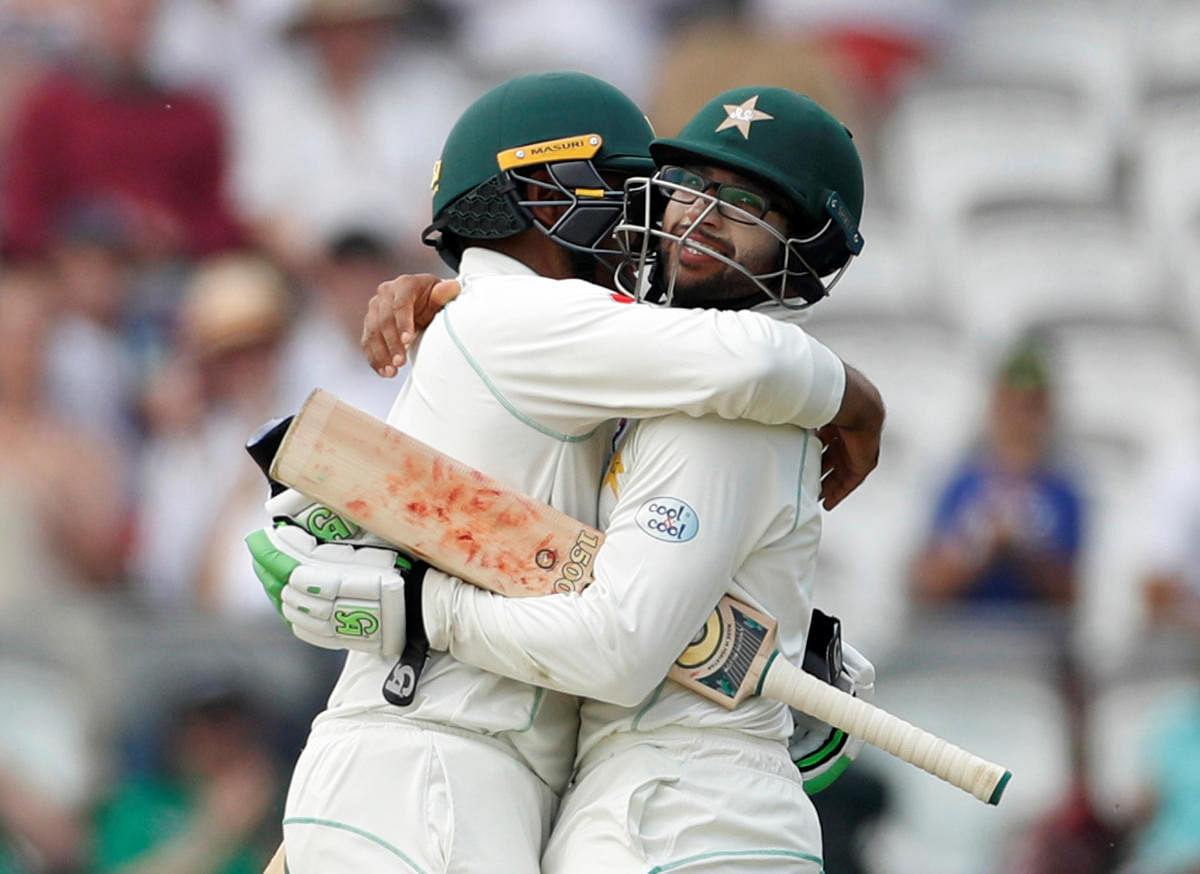 Pakistan's Imam-ul-Haq (right) and Haris Sohail celebrate after beating England in the first Test at Lord's on Sunday. Reuters