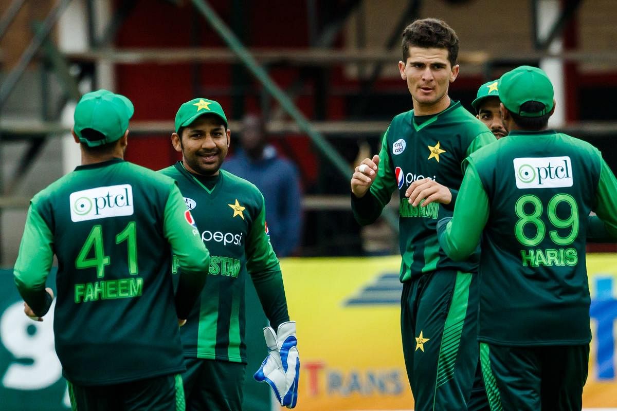 Pakistan's Shaheen Afridi (second from right) celebrates with team-mates after scalping an Australian batsman on Thursday. AFP
