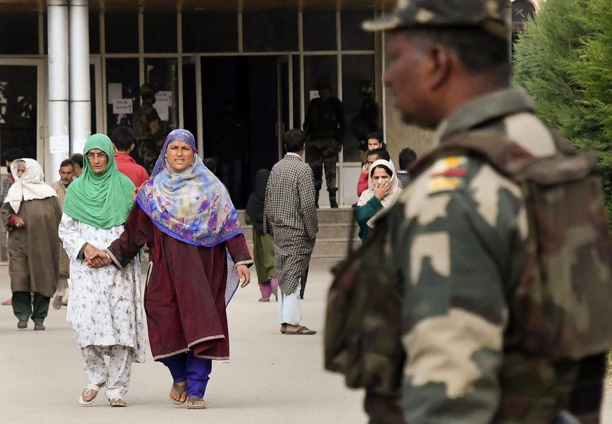 Women voters leave after casting their votes at a polling station during the 2nd phase of Municipal elections, in Sumbal area of Bandipora, on Wednesday. PTI