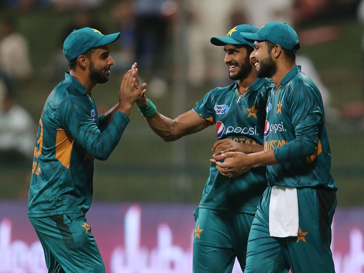 DELIGHTED: Pakistan's Hasan Ali (centre) celebrates with team-mates with team-mates after dismissing Australia's Adam Zampa during the first Twenty20 in Abu Dhabi. AFP