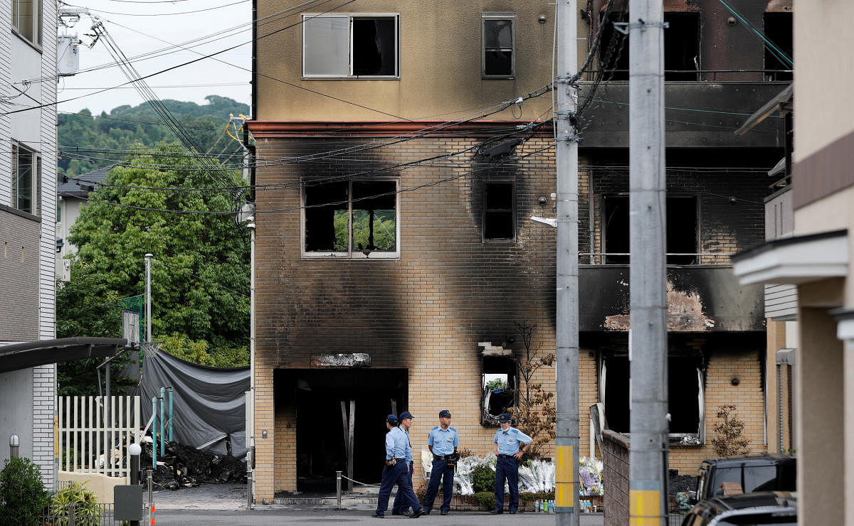 Policemen are seen at the torched Kyoto Animation building in Kyoto. (Reuters Photo)