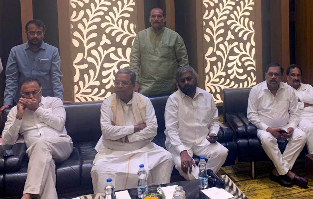 Congress leaders Siddaramaiah, Dinesh Gundu Rao and G Parameshwara at the CLP meeting in Bengaluru on Sunday.