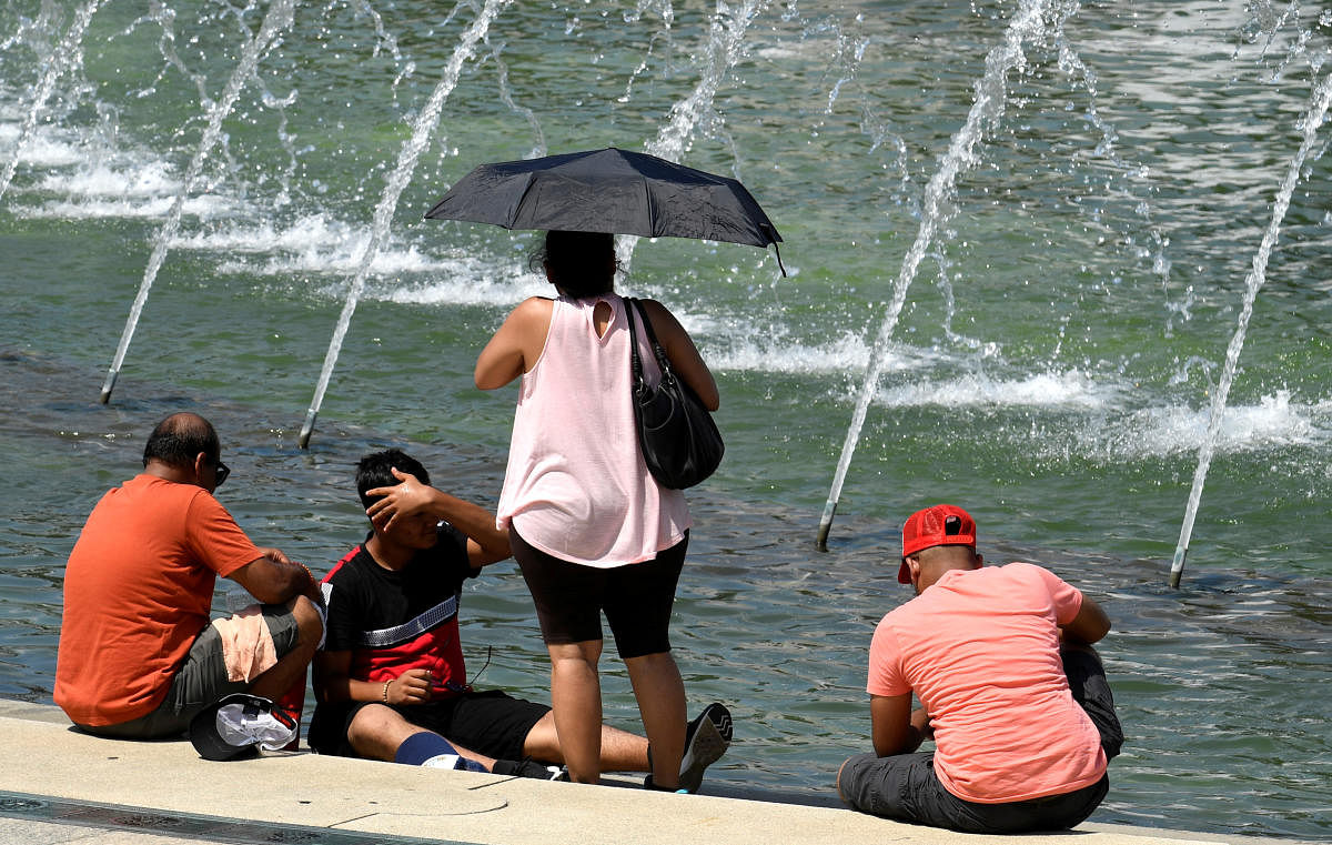 Tourists attempt to cool off at a fountain at the World War II Memorial on the National Mall during a heat wave, in Washington, DC (Reuters Photo)