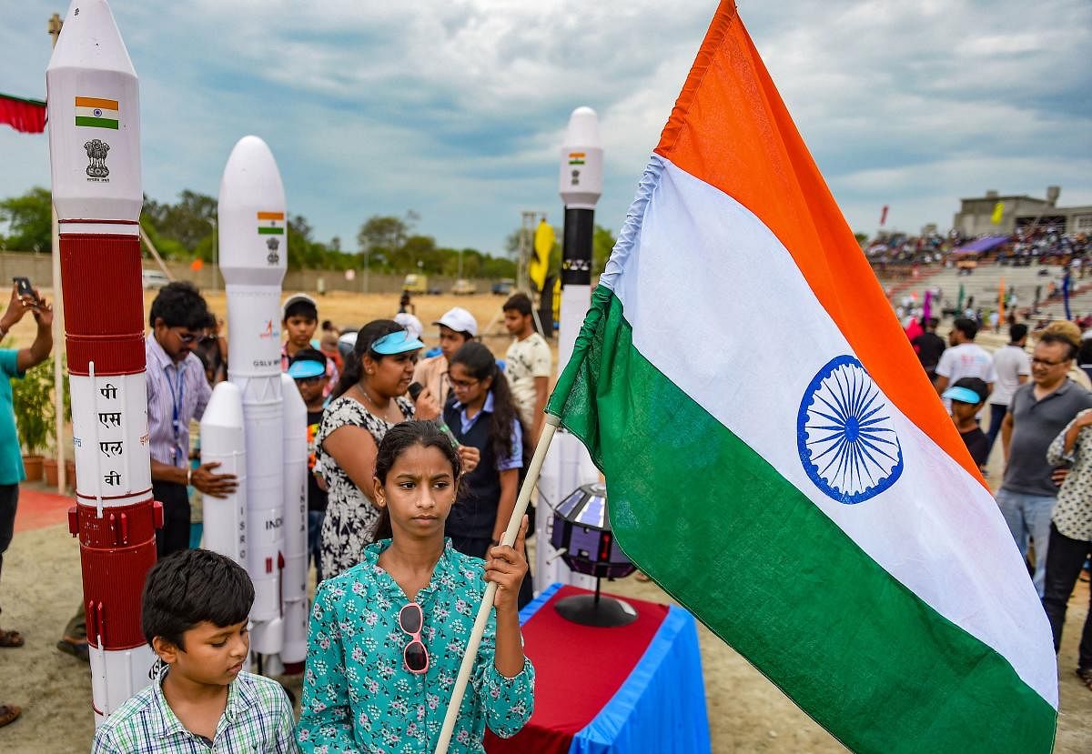 People celebrate with a Tricolour the successful launch of India’s second Moon mission Chandrayaan-2 by GSLV Mk III-M1 launch vehicle, in Sriharikota, Andhra Pradesh, Monday, July 22, 2019. Photo credit: PTI