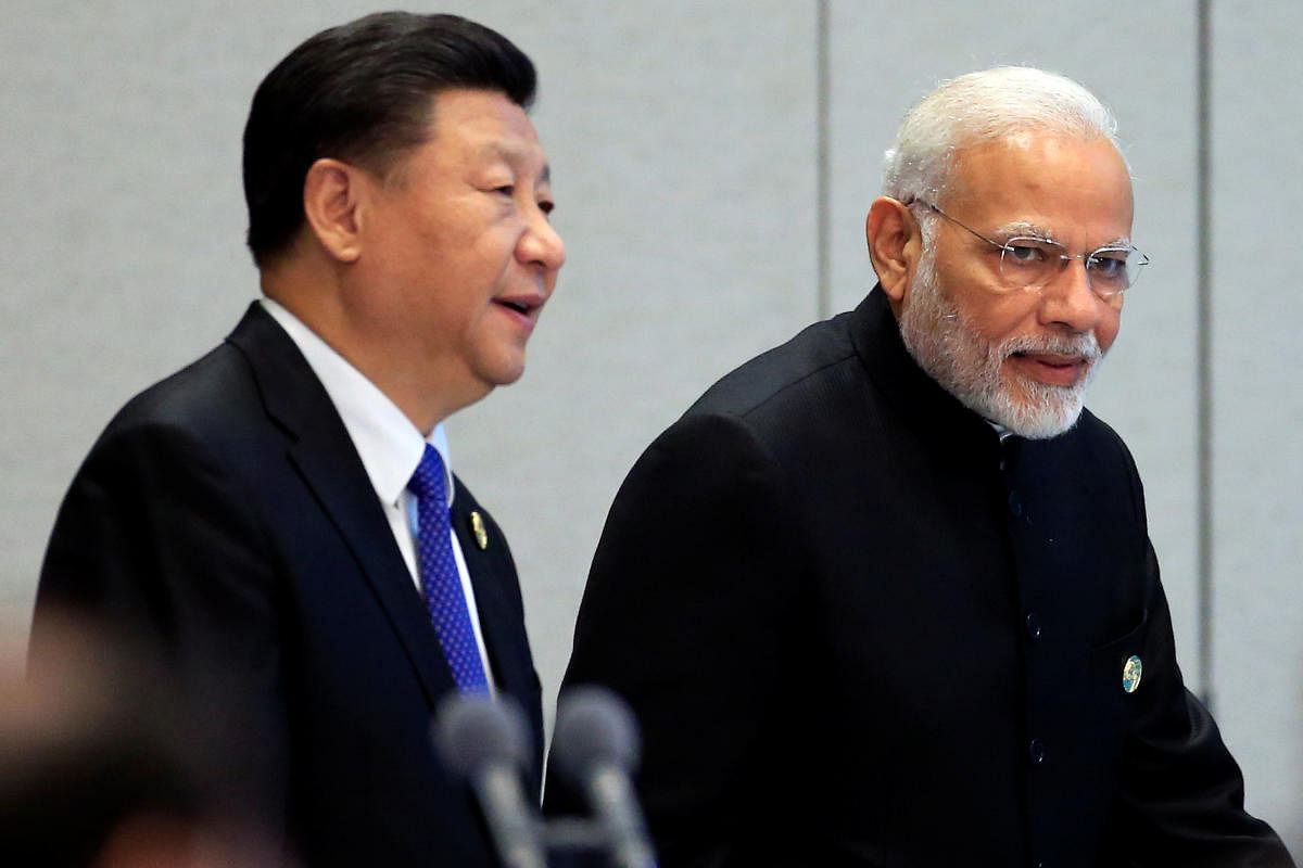 China's President Xi Jinping and India's Prime Minister Narendra Modi arrive for a signing ceremony during Shanghai Cooperation Organization (SCO) summit in Qingdao, Shandong Province, China. Reuters photo.