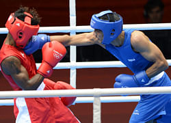 Indian boxer Jai Bhagwan lands a right on  Andrique of Seychelles during their Men's light boxing bout at the London Olympics. DH file photo