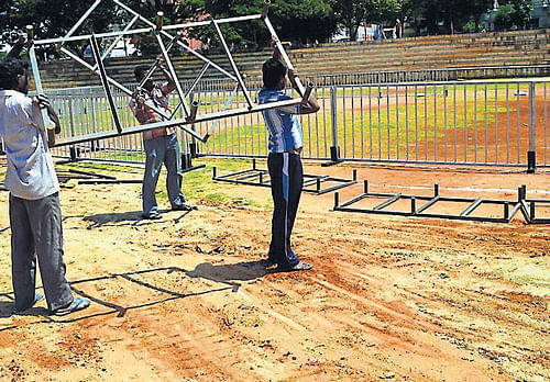 Work in progress to erect a huge dais to hold Congress convention to be attended by AICC president Sonia Gandhi, in Mandya, on Friday. dh photo