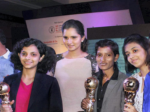Ace tennis player Sania Mirza poses with sportswomen from Odisha during an event in Bhubaneswar on Sunday. PTI Photo