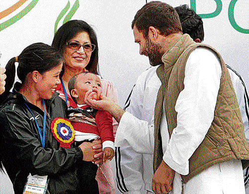 for the future: Congress vice-president Rahul Gandhi interacts with boxer Mary Kom's child at the launch of the Rajiv Gandhi Khel Abhiyan and National Youth Policy, 2014, at the Jawaharlal Nehru Stadium in New Delhi on Friday. pti