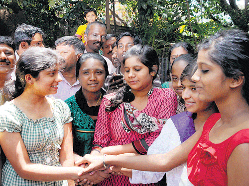 Students congratulate each other on their success in SSLC examinations, at a school in Bangalore on Monday. DH photo