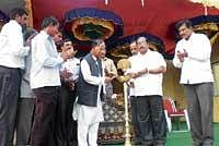 Minister in charge of district  Mumtaz Ali Khan inaugurating the state level day-night football tournament.  Legislator K P Bacche Gowda is also seen. DH PHOTO