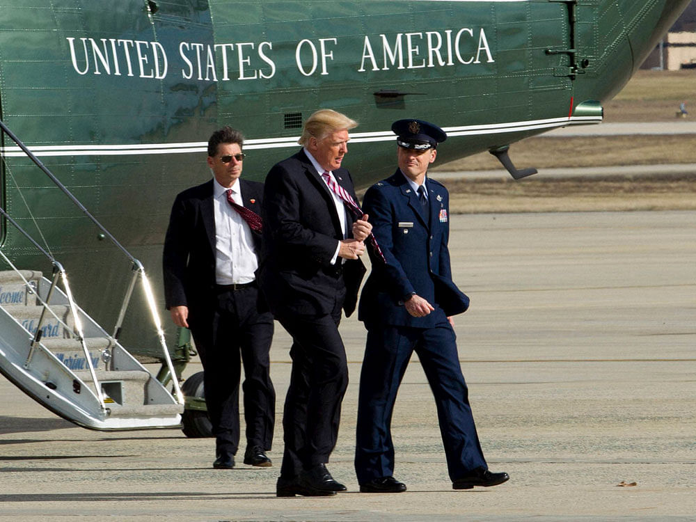 President Donald Trump is escorted by Col. Christopher M. Thompson, Vice Commander, 89th Airlift Wing, upon his arrival on Marine One at Andrews Air Force One, Md., Thursday, Jan. 26, 2017. Trump boarded Air Force One for a trip to Philadelphia to speak at the House and Senate GOP lawmakers at their annual policy retreat. AP/ PTI