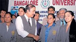proud moment Swimmer Tejaswini is being congratulated by Bangalore University  vice-chancellor N Prabhudev at a felicitation function on Monday. DH photo