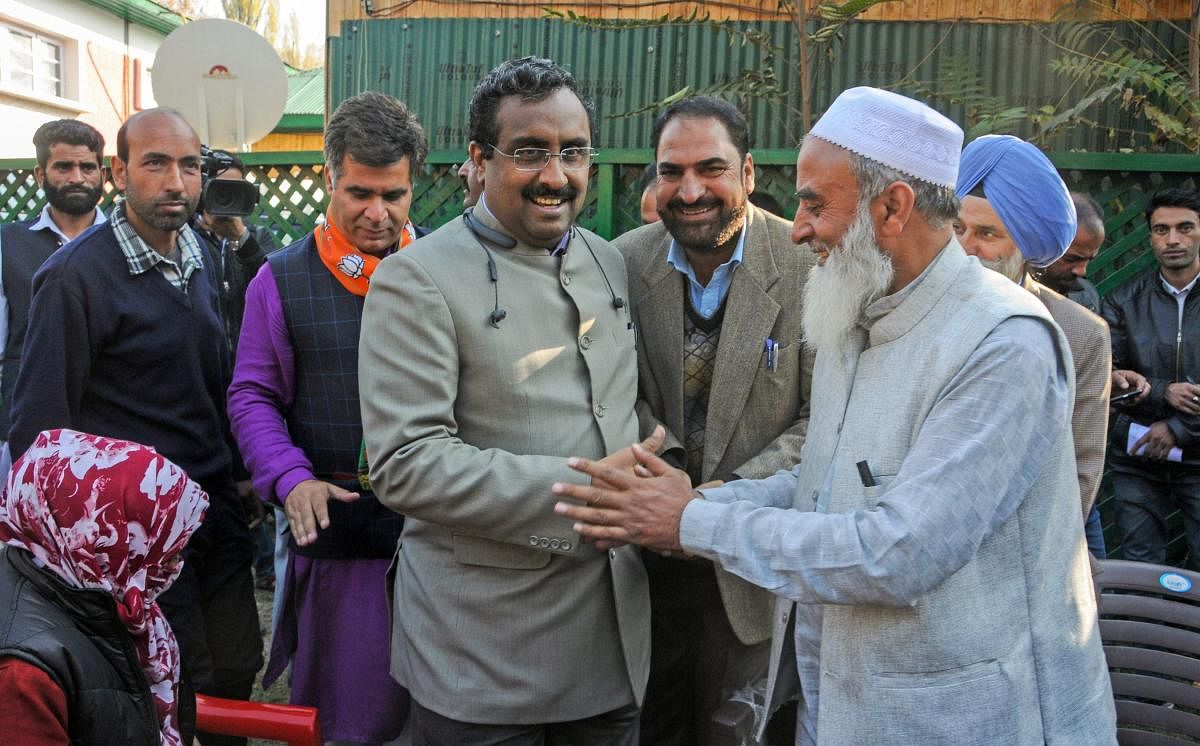 Bharatiya Janata Party (BJP) National General Secretary Ram Madhav interacts with a supporter during a rally to celebrate the party's victory in the recent urban local bodies elections, in Srinagar. PTI File photo