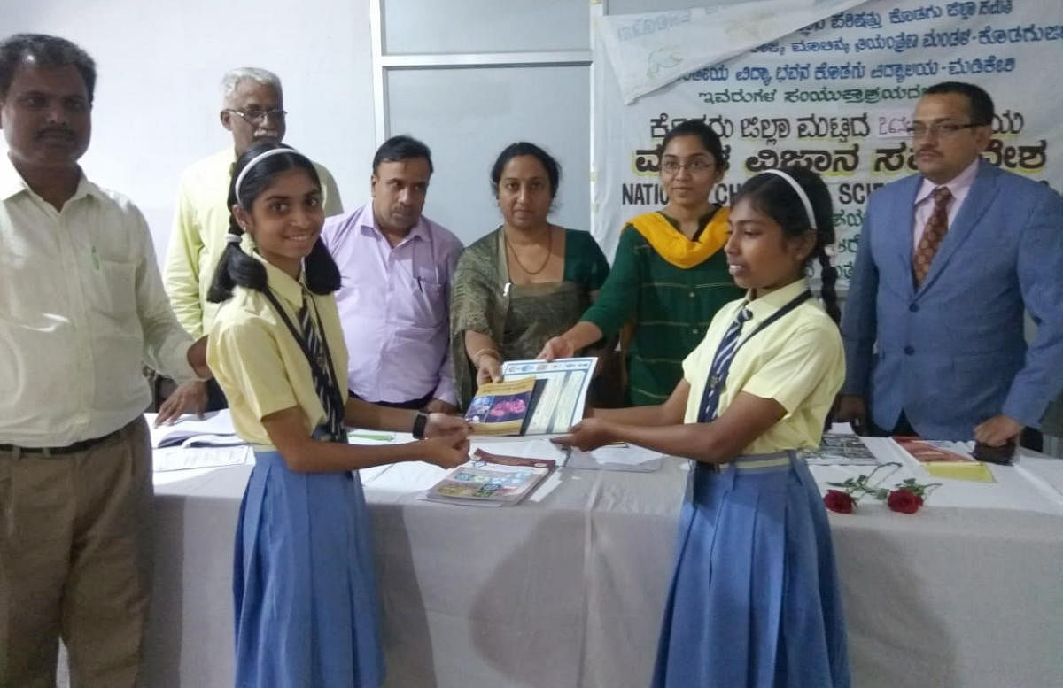 Zilla Panchayat CEO K Lakshmipriya awards the certificate of selection to two of the students selected for the state-level children’s science convention organised by Rajya Vijnana Parishat.