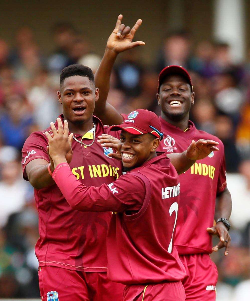 West Indies' Oshane Thomas (left) celebrates with team-mates after dismissing Pakistan's Mohammad Hafeez on Friday. Reuters