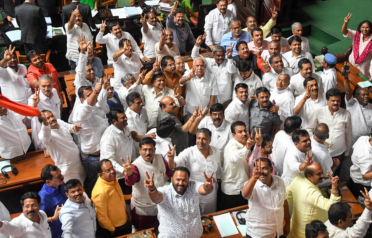 BJP State President BS Yeddyurappa with his party MLAs show victory sign after HD Kumaraswamy lost the vote of confidence at Vidhana Soudha, in Bengaluru, Tuesday. Photo/ B H Shivakumar