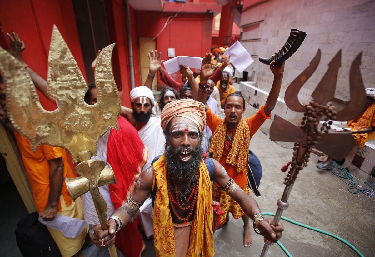 Jammu: Pilgrims chant religious slogans as they stand in a queue to get themselves registered for Amarnath Yatra, at Ram Mandir base camp in Jammu. (PTI Photo)