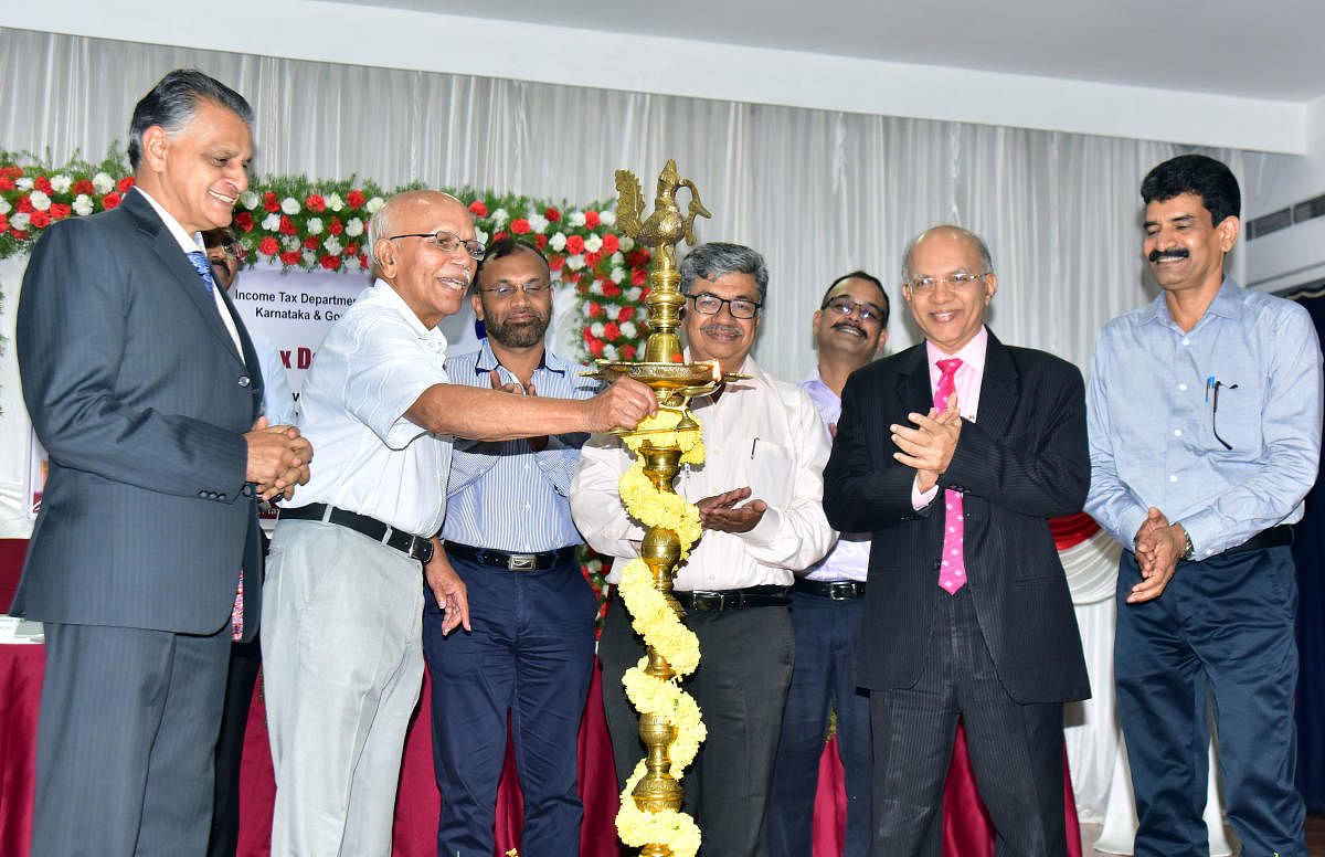 Dr B M Hegde, former vice chancellor of Manipal Academy of Higher Education, inaugurates the Income Tax Day programme at IMA Hall in Mangaluru on Wednesday.