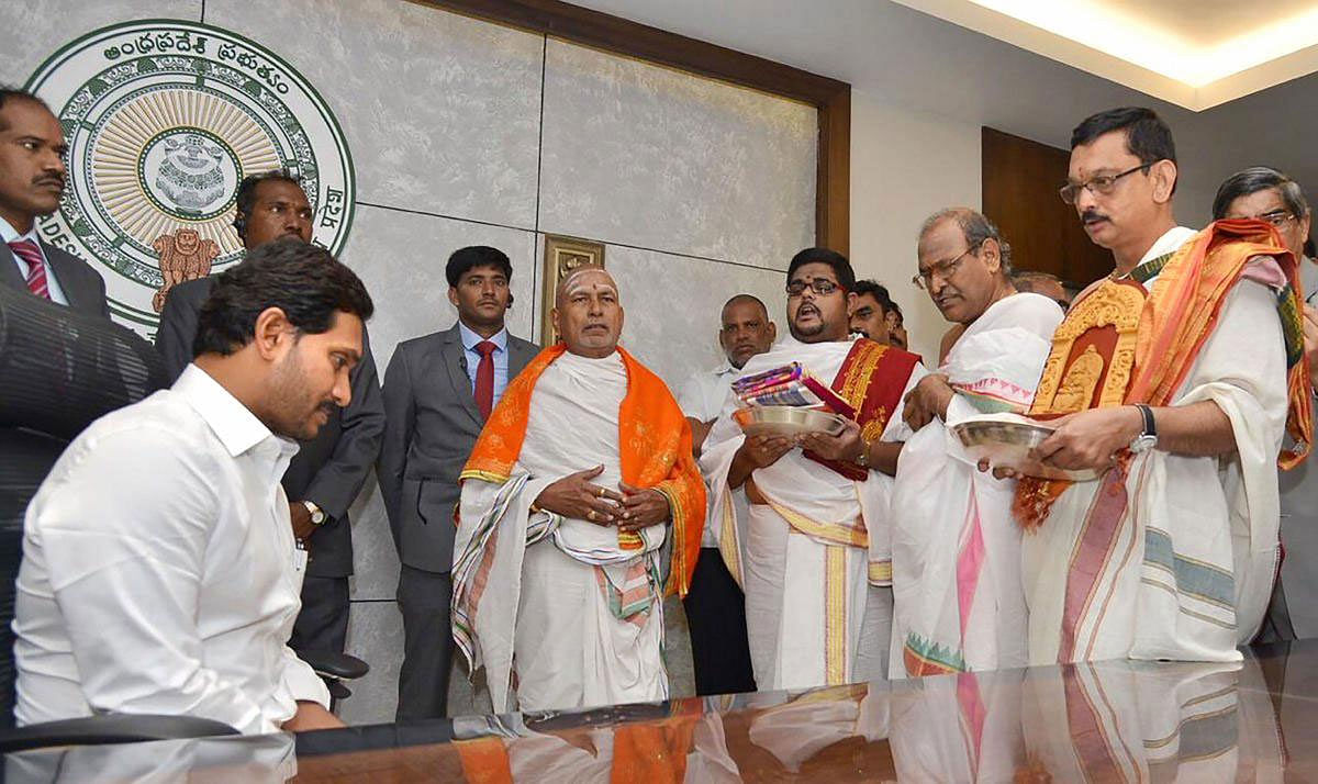 Andhra Pradesh Chief Minister YS Jaganmohan Reddy seeks blessings from Vedic scholars as he assumes charge of his office at state secretariat, after his victory in the state elections, in Amaravati, Saturday, June 8, 2019. (PTI Photo)