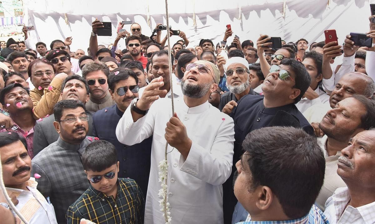 AIMIM chief and MP Asaduddin Owaisi hoists the party flag on the occasion of 61st AIMIM formation day celebrations at the party headquarter, in Hyderabad on March 2, 2019. PTI