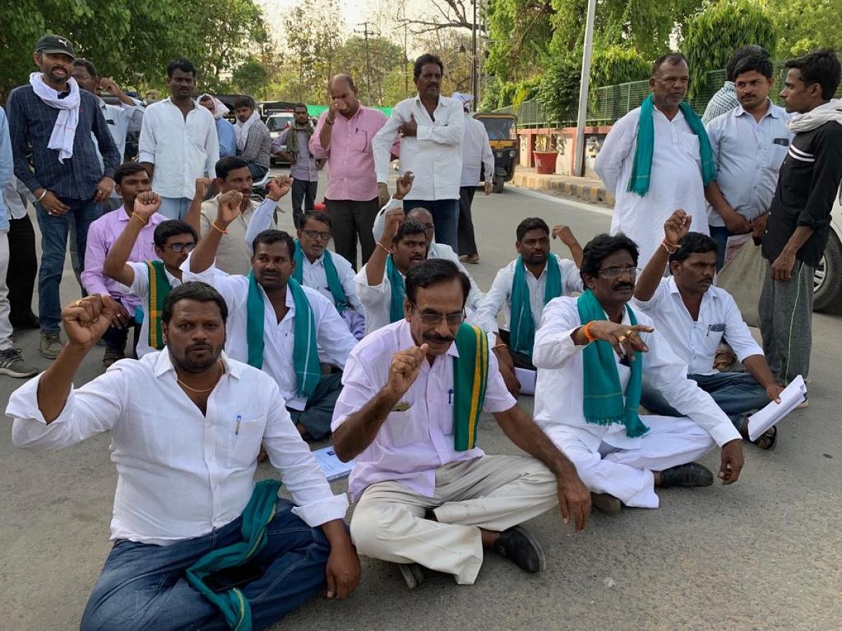 Turmeric farmers raise slogans in protest in Varanasi on Monday.