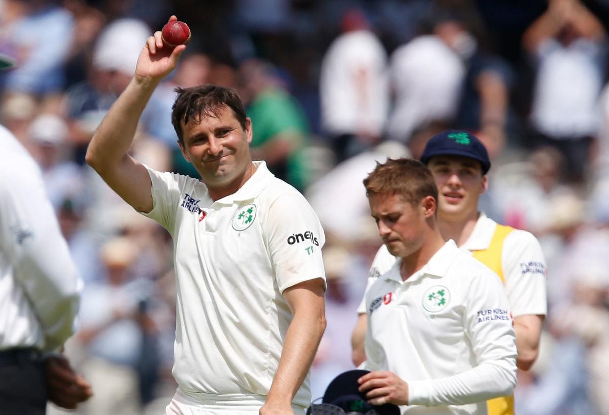 Ireland's Tim Murtagh walks off the field after taking 5 wickets and leaving England to bowl on the first day of the first cricket Test match between England and Ireland at Lord's cricket ground in London. (AFP Photo)