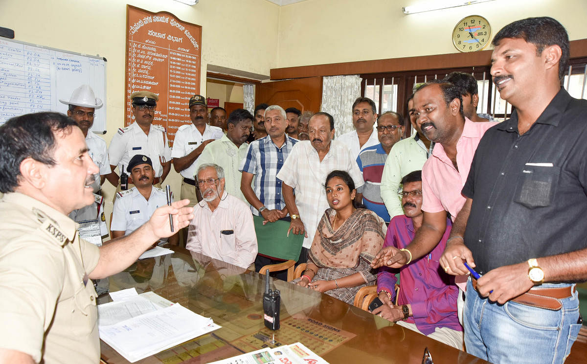 Traders request Assistant Commissioner of Police (Traffic) G N Mohan to relax no-parking norms at Santepet in Mysuru on Thursday.