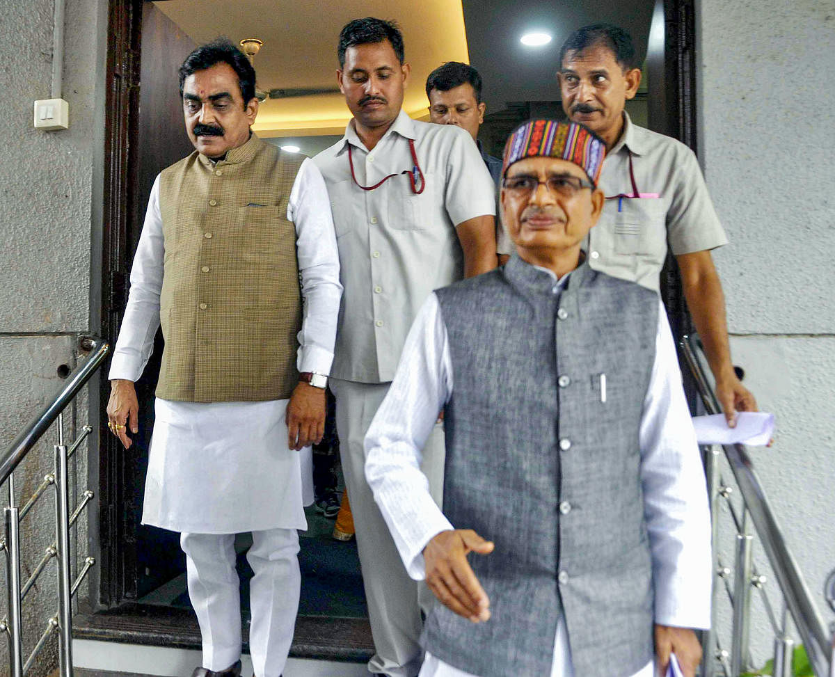 BJP national vice-president Shivraj Singh Chouhan and BJP state President Rakesh Singh leave after a meeting with state party leaders, in Bhopal, on Thursday. PTI