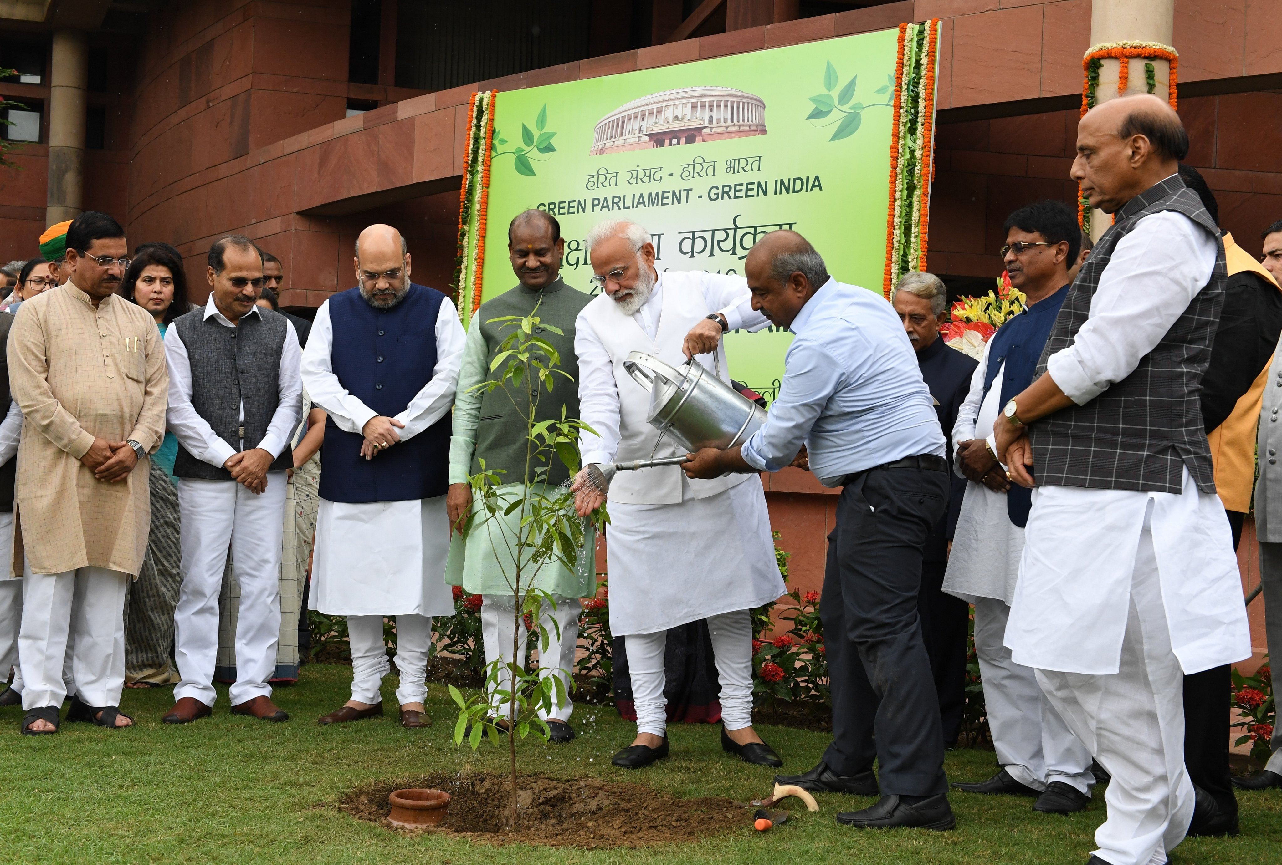 Modi, along with others, planted saplings during the drive. (PIB India/Twitter)