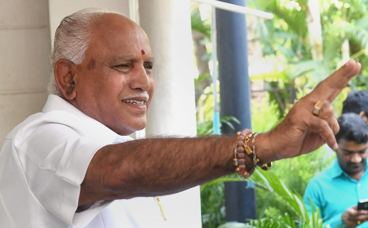 B S Yediyurappa shows victory sign during a press conference, a day after polling for Karnataka Assembly elections, in Bengaluru on Sunday. (PTI Photo)