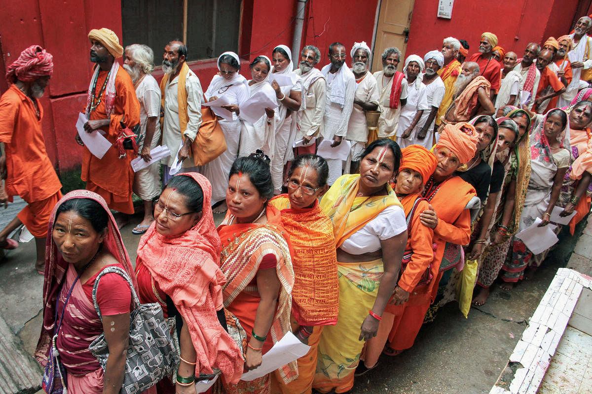 Pilgrims stand in queues to get themselves registered for Amarnath Yatra, at a base camp, in Jammu. (PTI Photo)