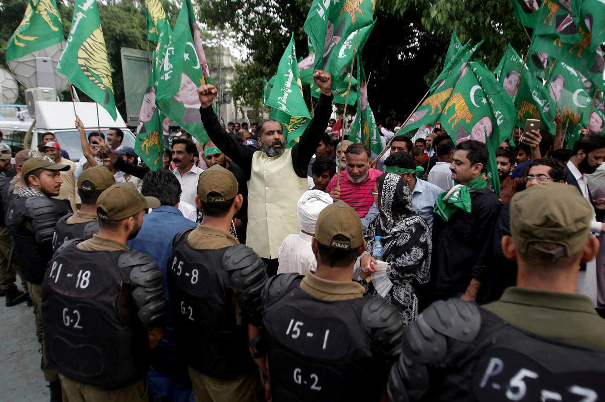 Supporters of Pakistan Muslim League - Nawaz (PML-N) chant slogans as police officers block the road during a countrywide protest called "Black Day" against the government of prime minister Imran Khan, in Lahore, Pakistan July 25, 2019. (REUTERS)