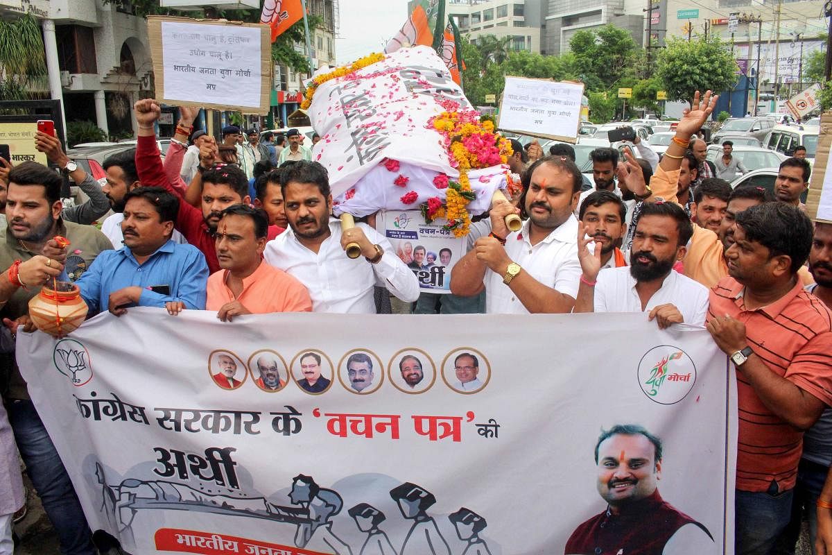 Bharatiya Janata Yuva Morcha (BJYM) activists take out a mock funeral rally of Congress party's election manifesto, over not fulfiling the promises made before the State Assembly elections, in Bhopal. Photo credit: PTI
